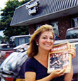 Ann holding a copy of Saratoga Living magazine, which she founded in 1998.
